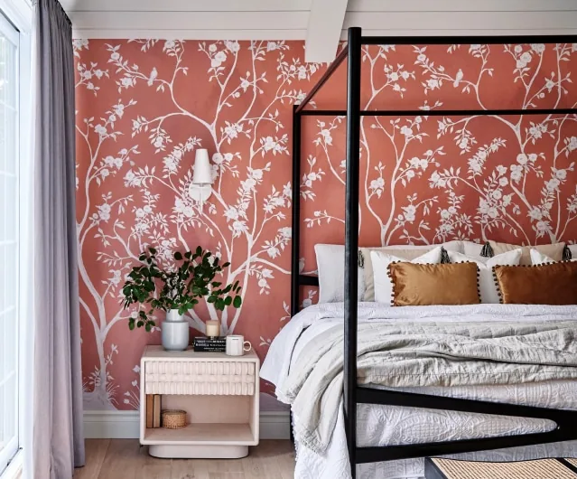 Warm bedroom with a soft floral wallpaper feature wall